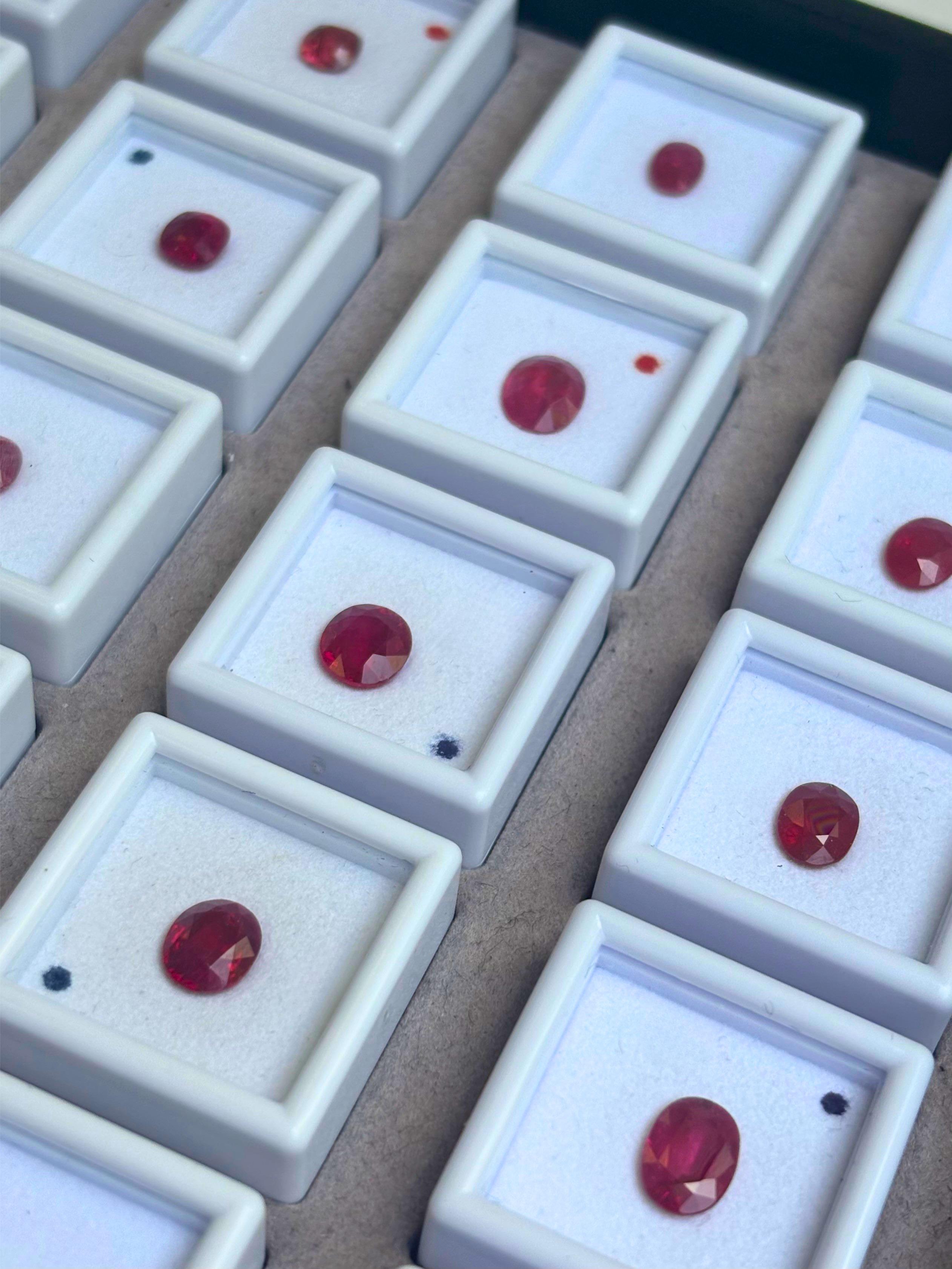 Selection of natural ruby gemstones from the CR Gems collection displayed in individual gem boxes for jewellery manufacturing and bespoke design.