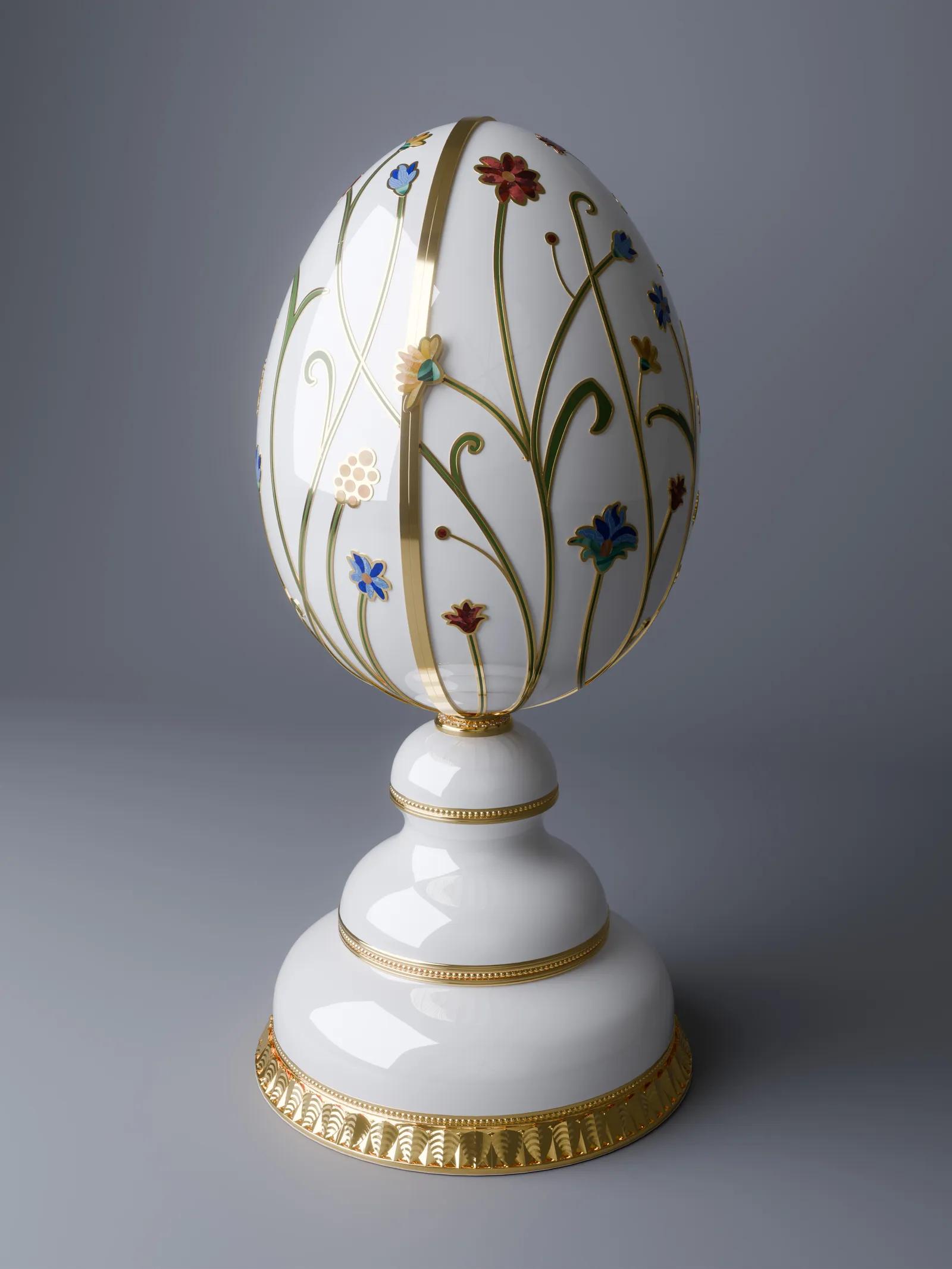 Faberg&eacute; Garden of Light Egg, a white and gold decorative egg featuring colourful floral motifs, displayed on an ornate white and gold pedestal
