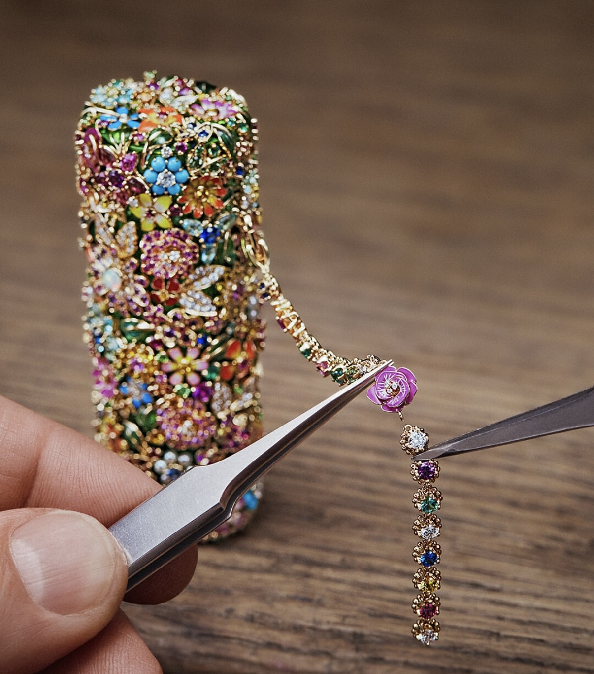 Detail of Dior’s Rouge Premier lipstick pendant, as artisans set a miniature rose and multicoloured gemstone chain—part of the sautoir transformation. Imagery: Courtesy of Dior