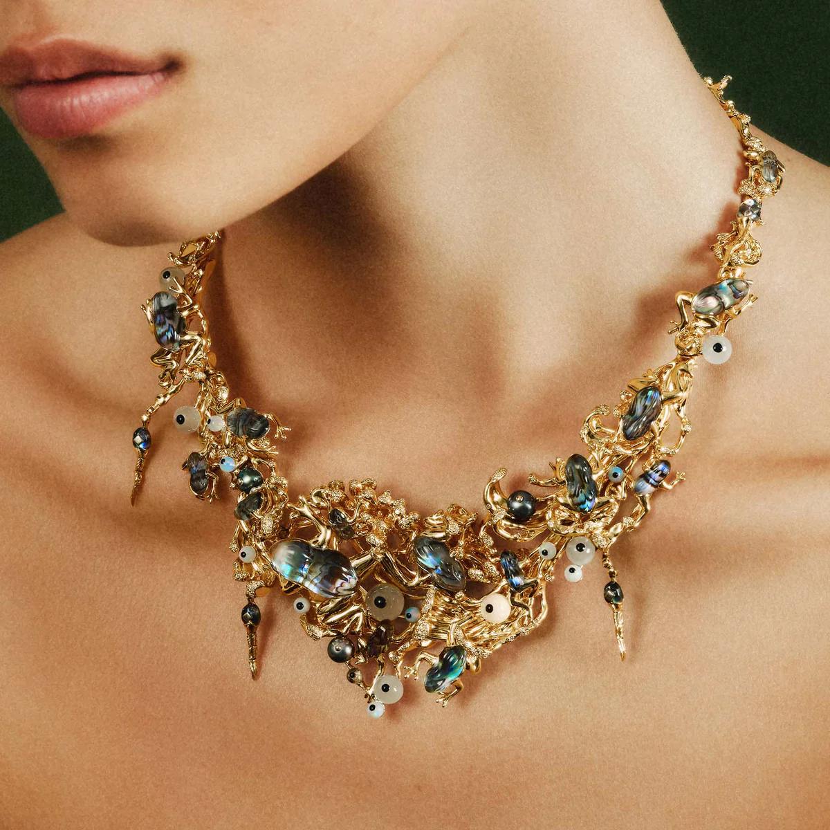 Close-up of Bibi van der Velden Guardians of the Forest necklace in 18ct gold with frog motifs, set with abalone, rock crystal, opal, moonstone and diamonds.