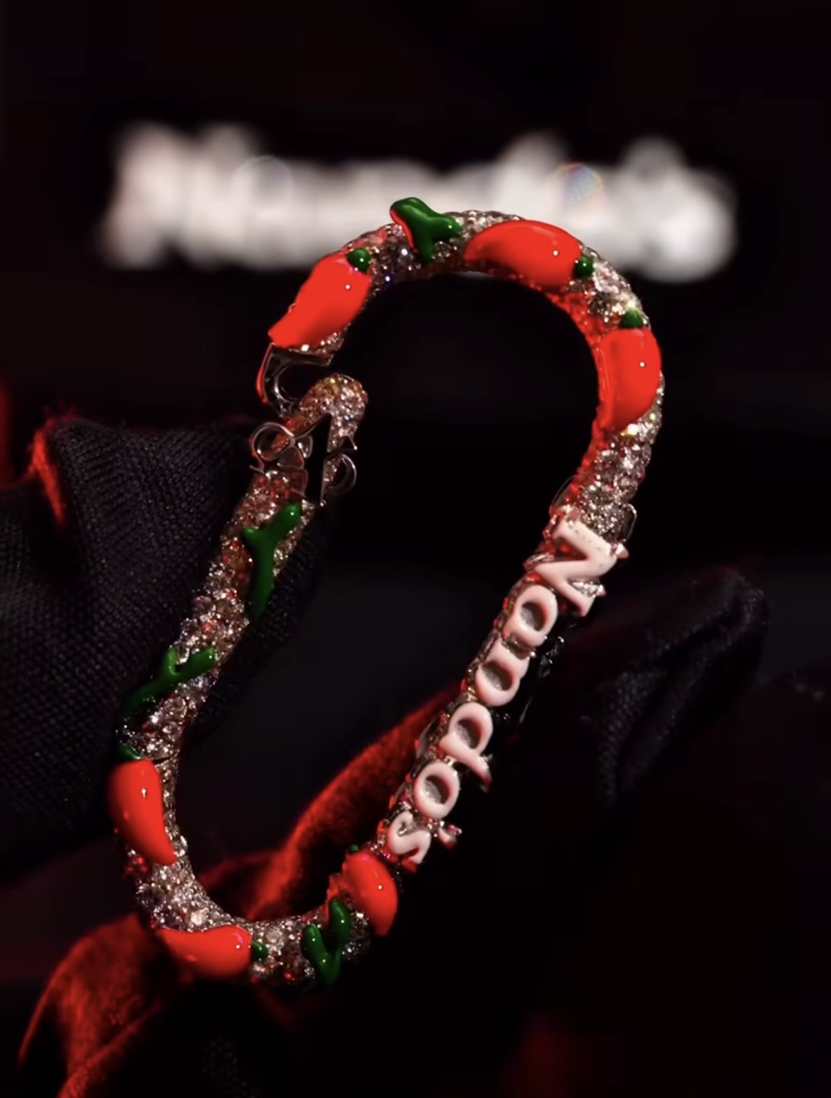 A closer look at the fully iced Nando’s clip, featuring hand-set diamonds and glossy enamel chillies wrapped around a white gold carabiner.  Photo credit: A Jewellers