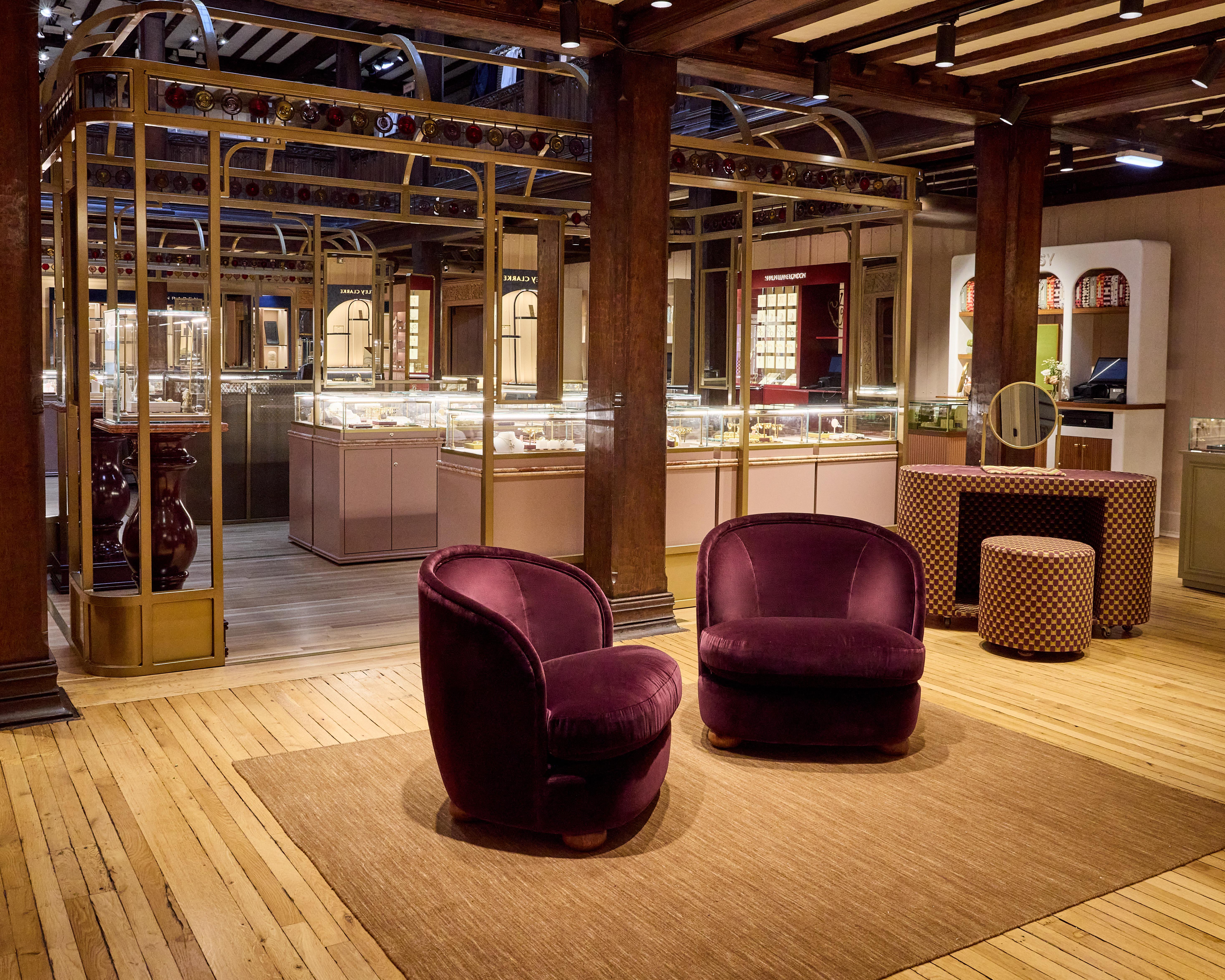 Liberty Fashion Jewellery Gallery with illuminated display cases, gold framework, wooden floors and burgundy velvet seating