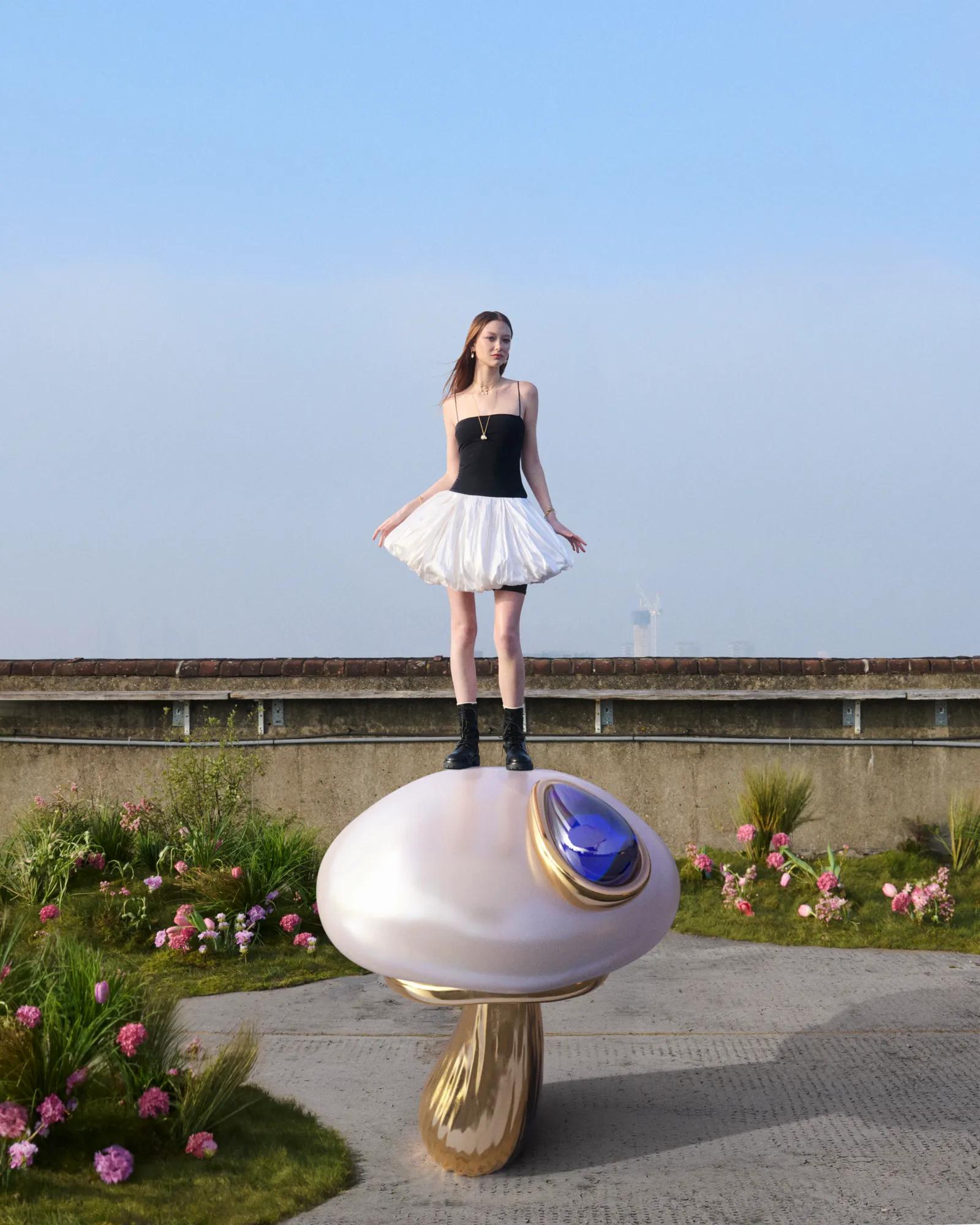 Model standing on a giant pearl-inspired mushroom installation created for the Pandora Wonders freshwater pearl collection campaign.