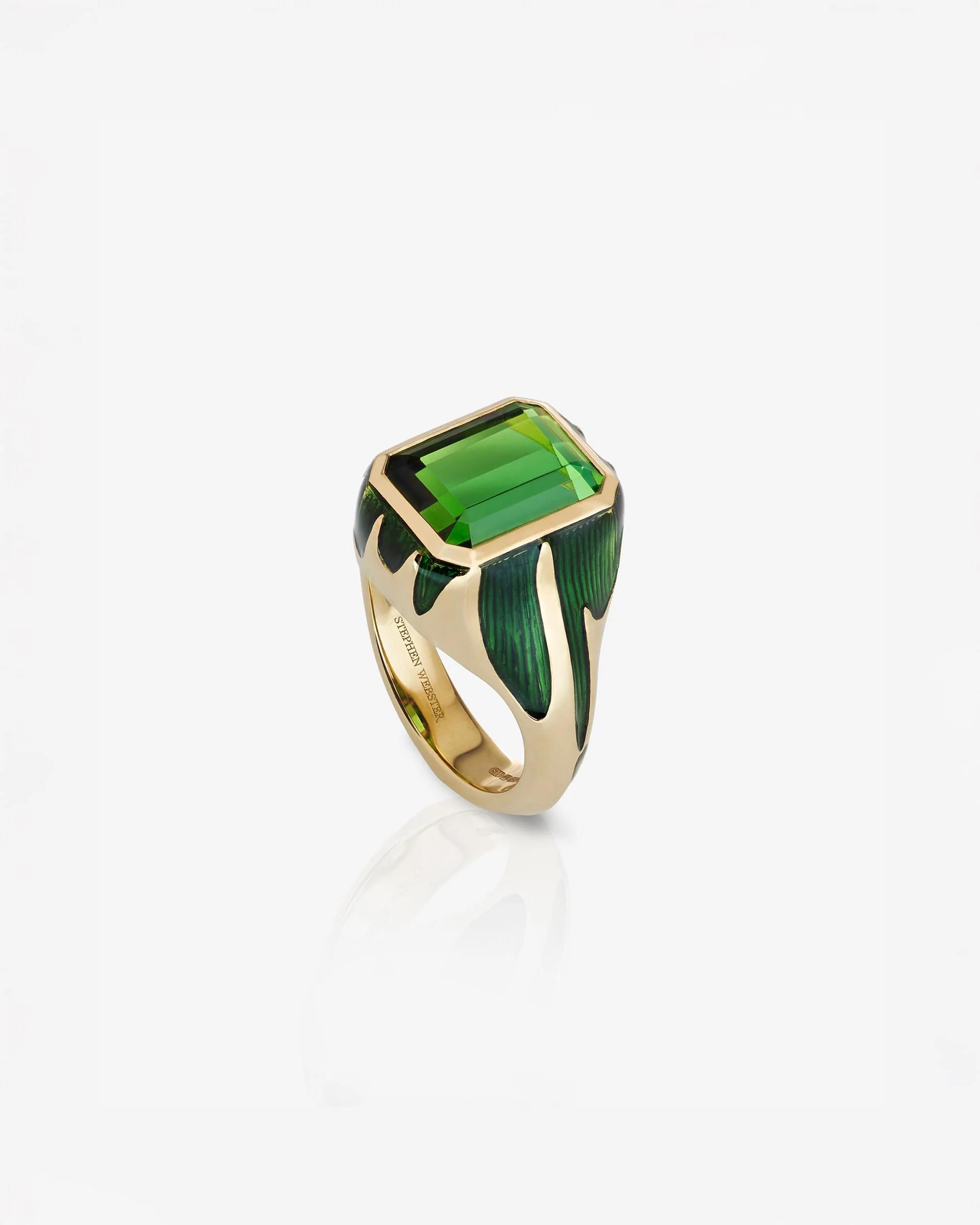 Side view of Stephen Webster&rsquo;s yellow gold signet ring with a rectangular green tourmaline and dripping green enamel details