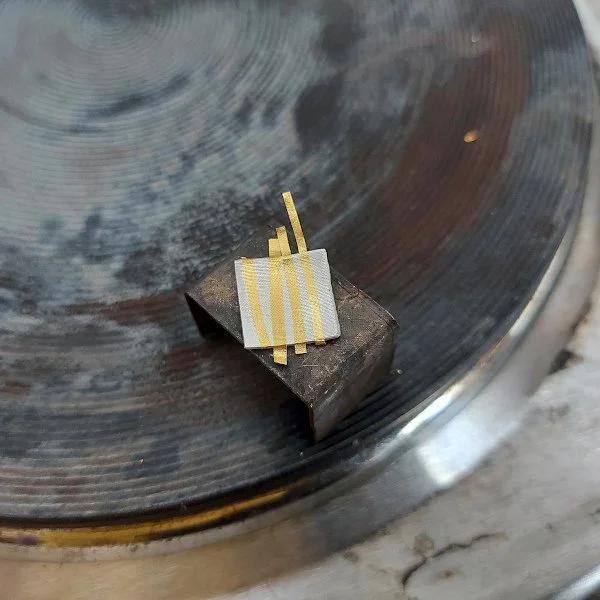 Fine strips of 24-carat gold foil positioned on silver before being bonded through the traditional Korean Keum-Boo process. Photo: Hendrike Barz-Meltzer