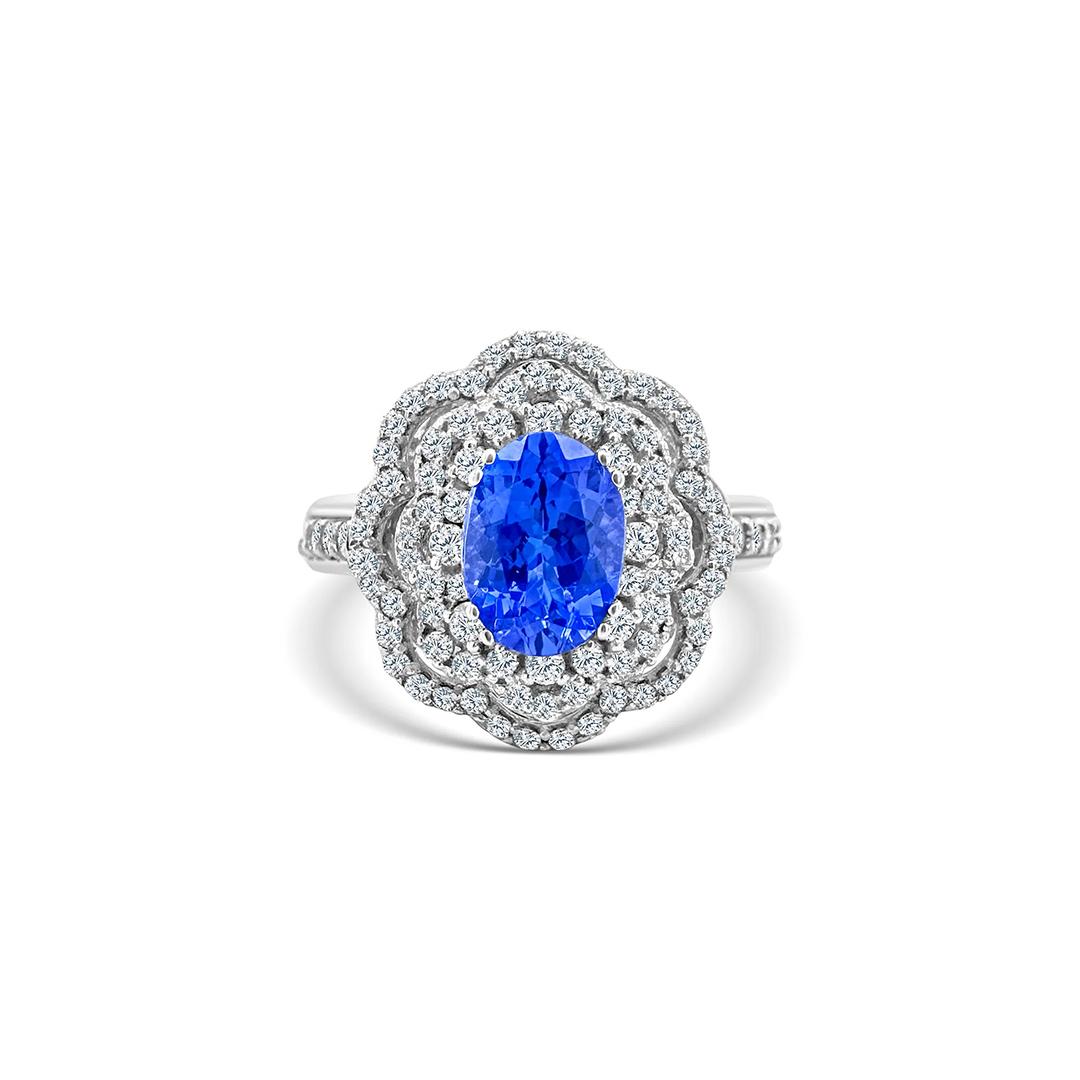 Tash High Jewellery ring with an oval vivid-blue centre stone encircled by layered floral halos of white diamonds