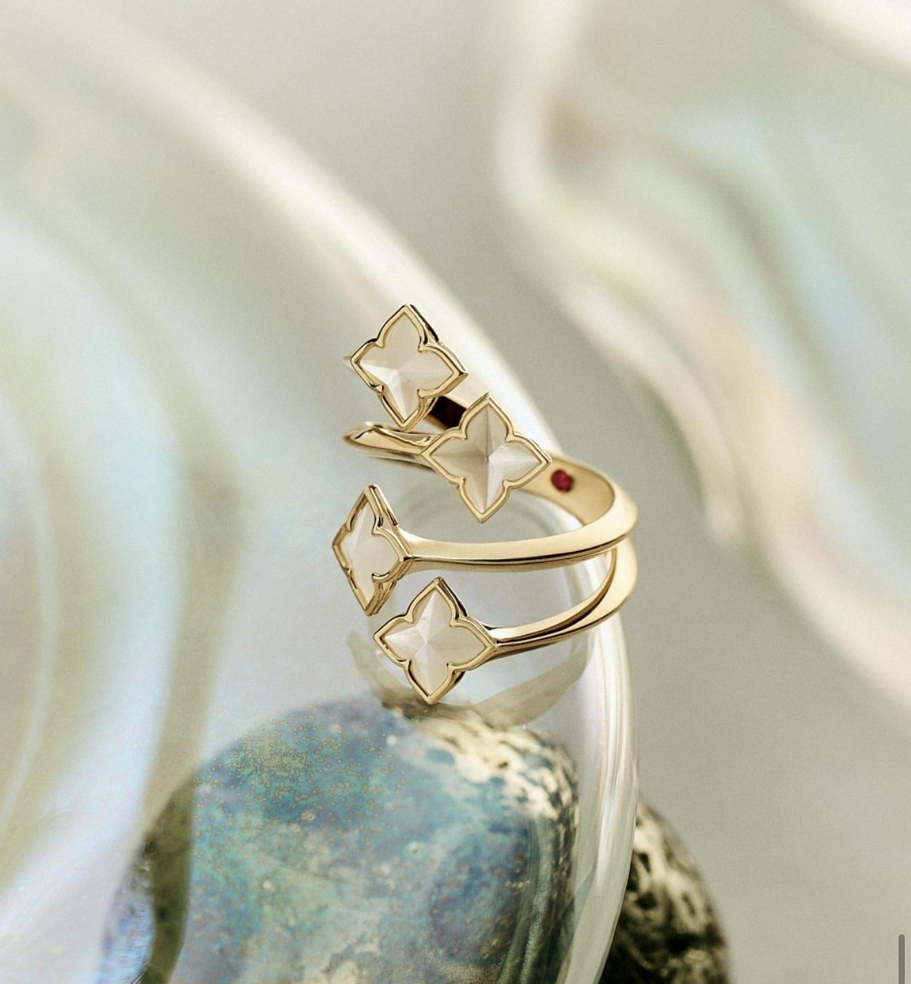 Gold Roberto Coin Venetian Princess ring with pale floral motifs and a small hidden ruby on the inside of the band
