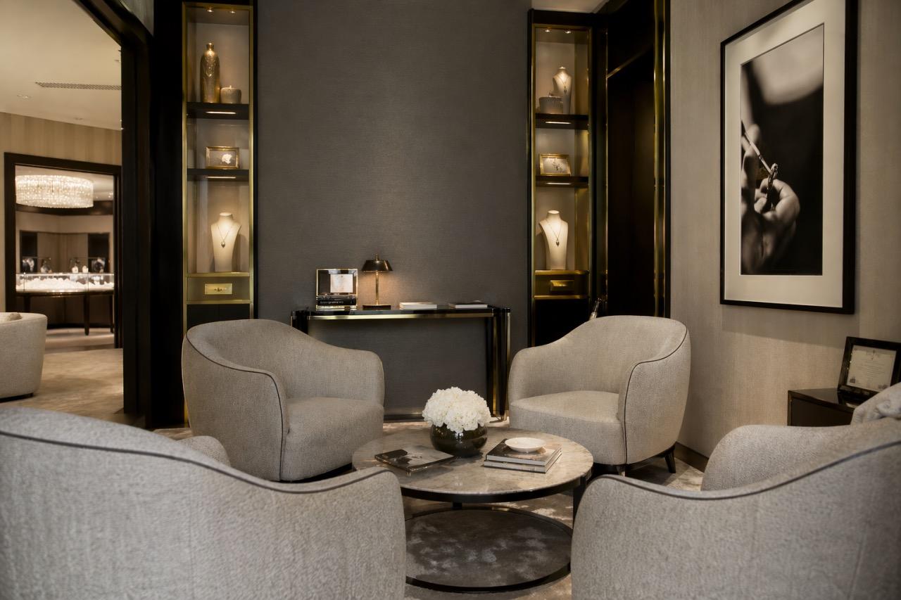 A luxury showroom seating area with armchairs, display cabinets and soft lighting, designed for private client appointments.