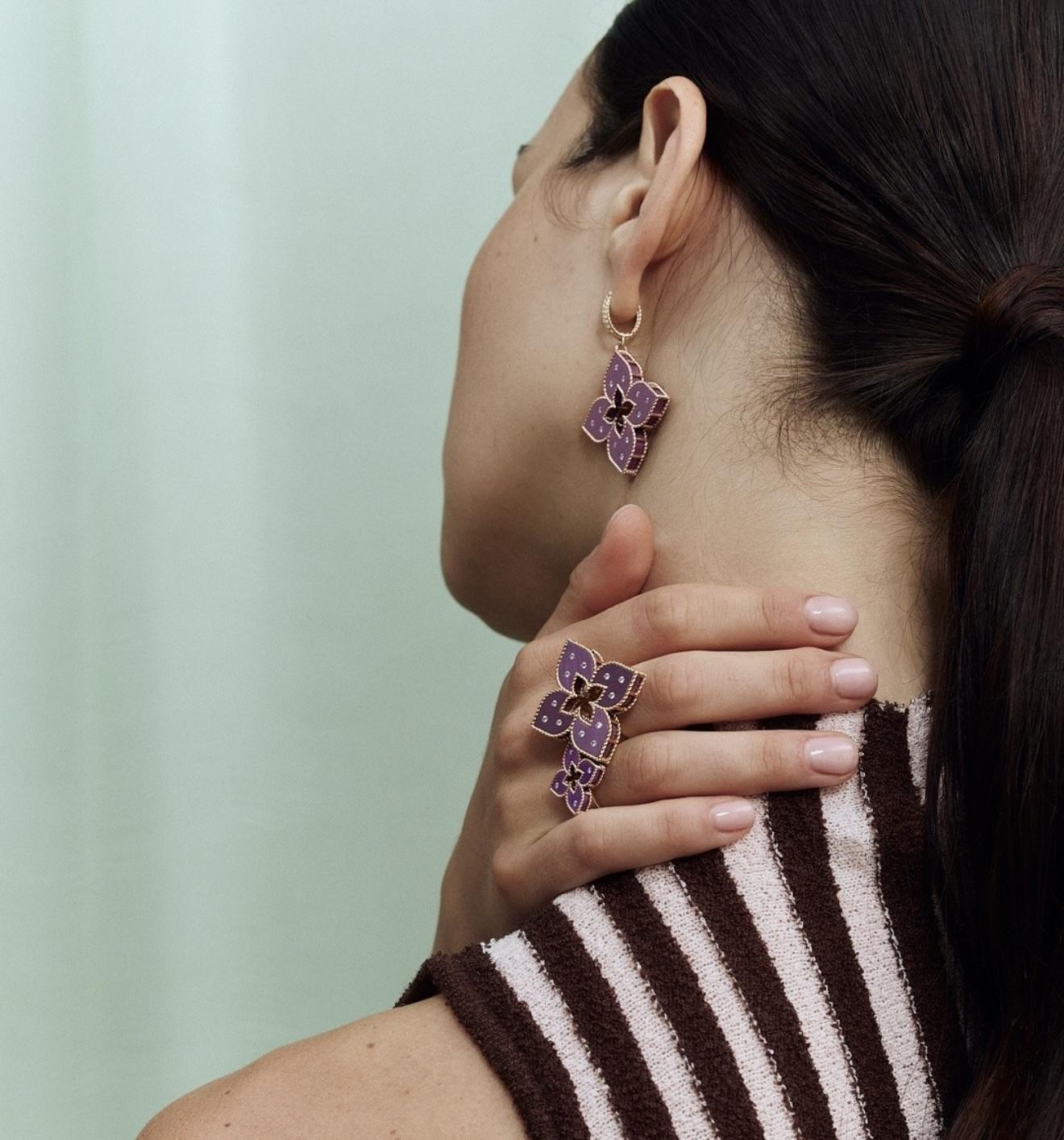 Model wearing violet floral Venetian Princess earrings and matching ring by Roberto Coin.
