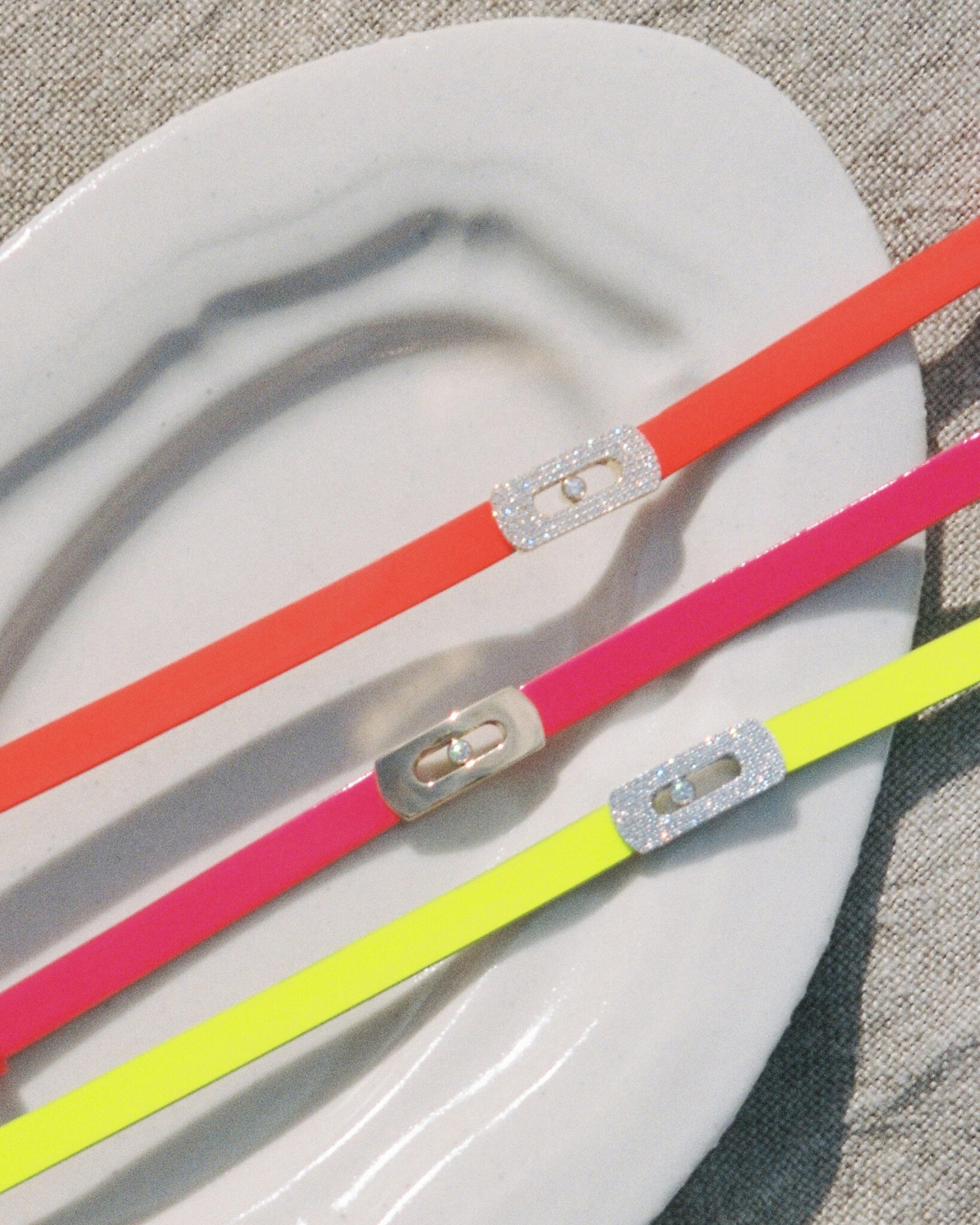 Electric pink, neon yellow and orange — Messika’s My Move bracelets dial up the colour for summer, blending high-impact hue with signature diamonds. Photo © Nicolas Kutler for Messika.