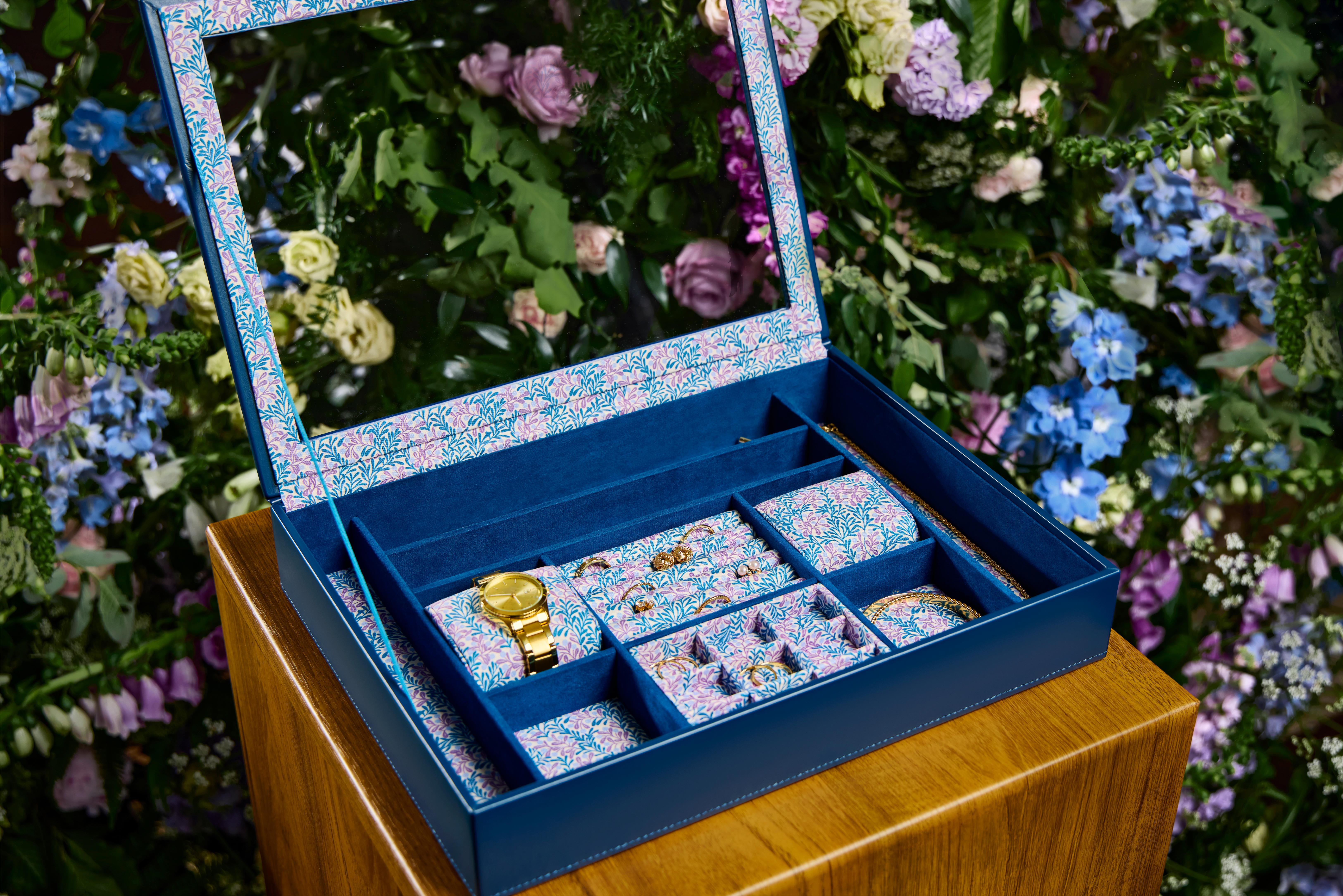 Open blue WOLF Sophia jewellery box lined with Fiona Howard’s colourful botanical print.