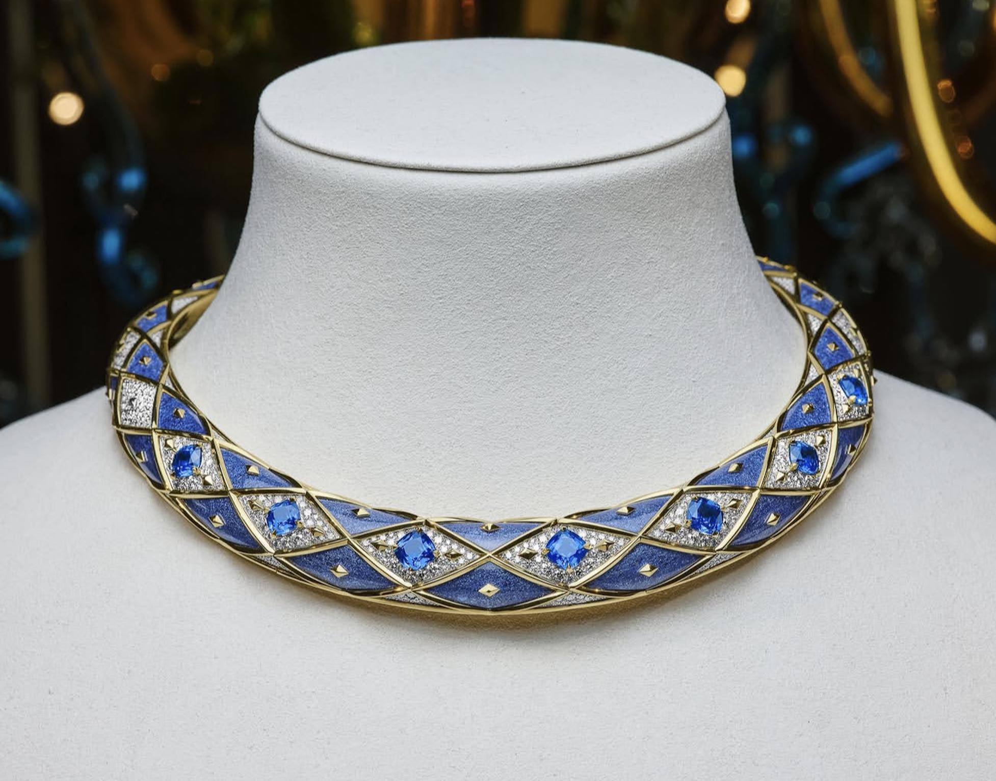 Tiffany high jewellery collar with blue gemstones, diamond sections and gold lattice details displayed on a white bust