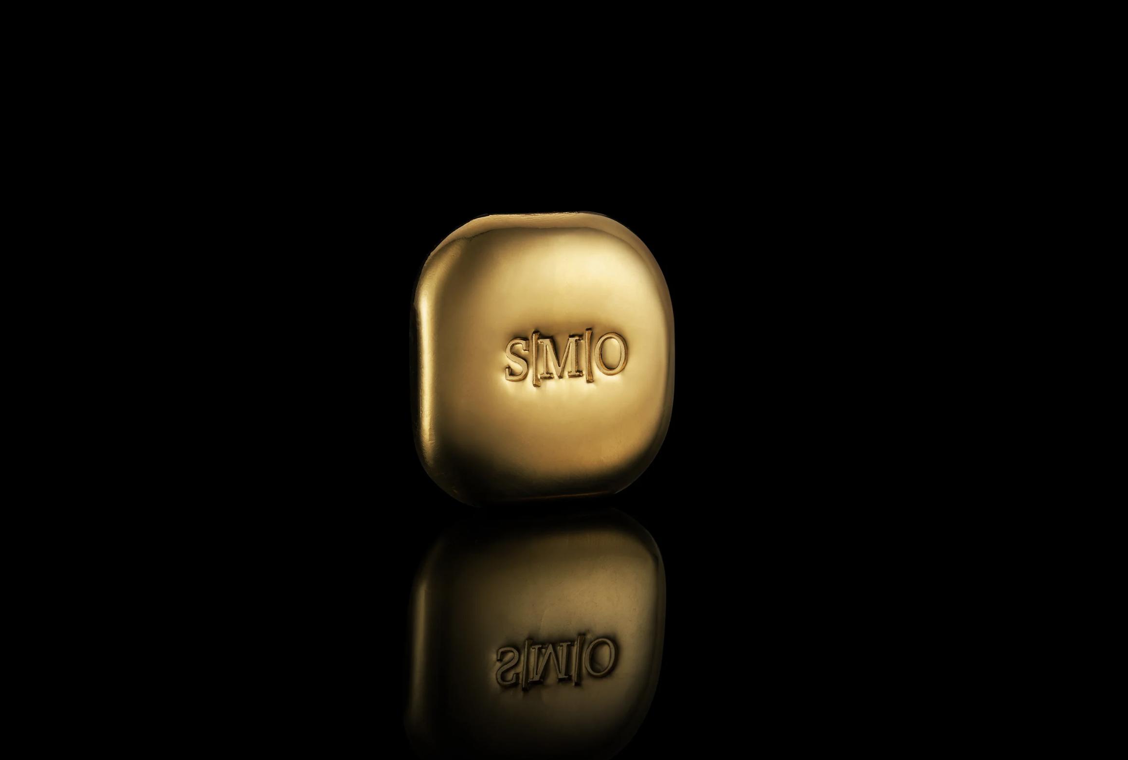 Gold nugget engraved with SMO logo on a black background representing Single Mine Origin gold