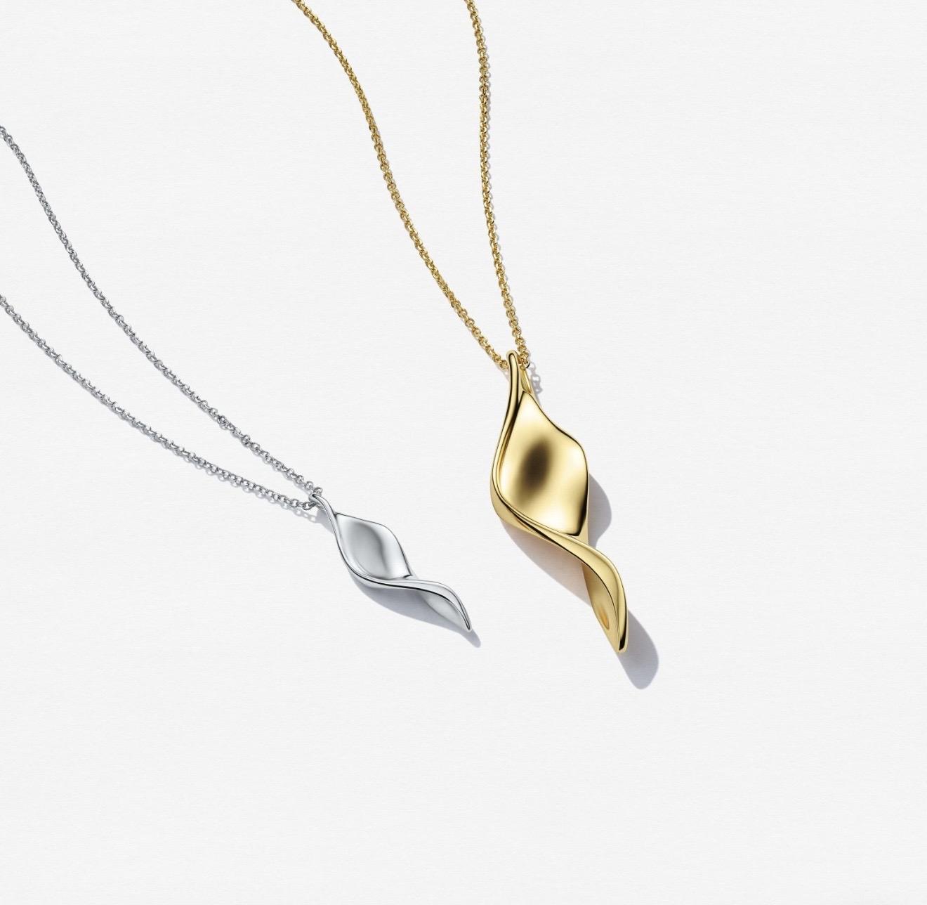 Two Foglia pendant necklaces from Sif Jakobs Jewellery, featuring organic leaf-inspired designs in polished gold-tone and silver-tone finishes suspended from fine chains.
