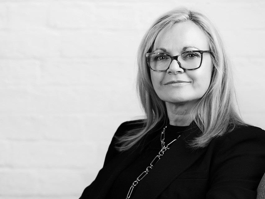 Portrait of Judith Lockwood, Strategic Industry Advisor at ValuCert, wearing glasses and a black blazer.
