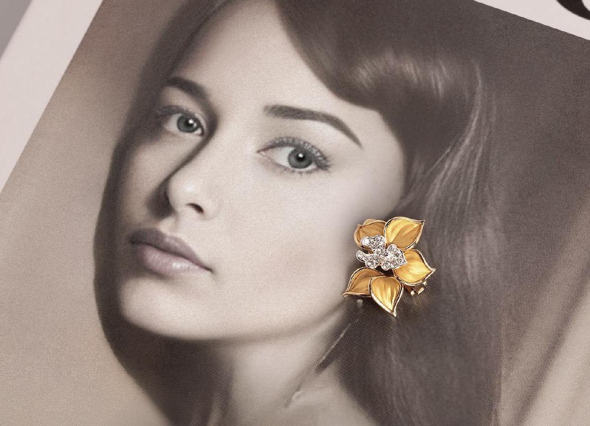 Vintage Carrera y Carrera campaign image featuring a sculptural yellow gold orchid jewel with diamond-set centre against a portrait background.