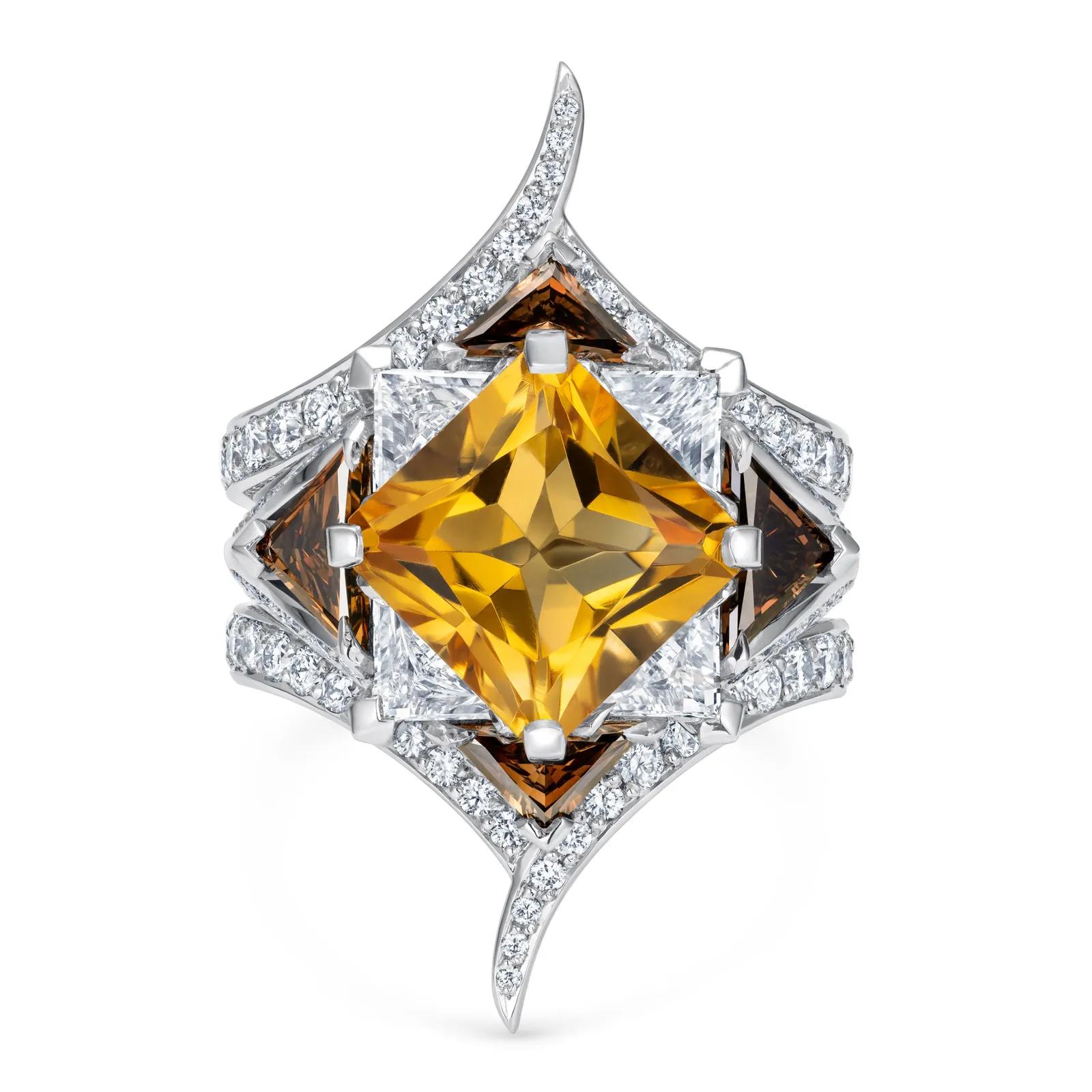 Sculptural white-metal ring featuring a large square-cut golden gemstone, triangular brown and colourless stones, and curved rows of white diamonds