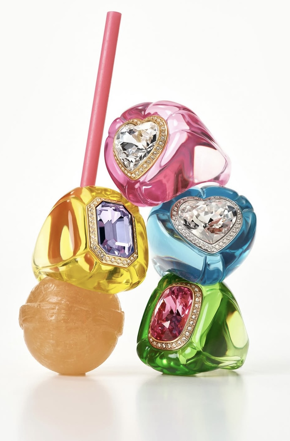 Image courtesy of Swarovski A stack of Dulcis rings channels full sweet-shop fantasy — heart-shaped and cushion-cut crystals in bold glossy frames, styled like jewels on a stick