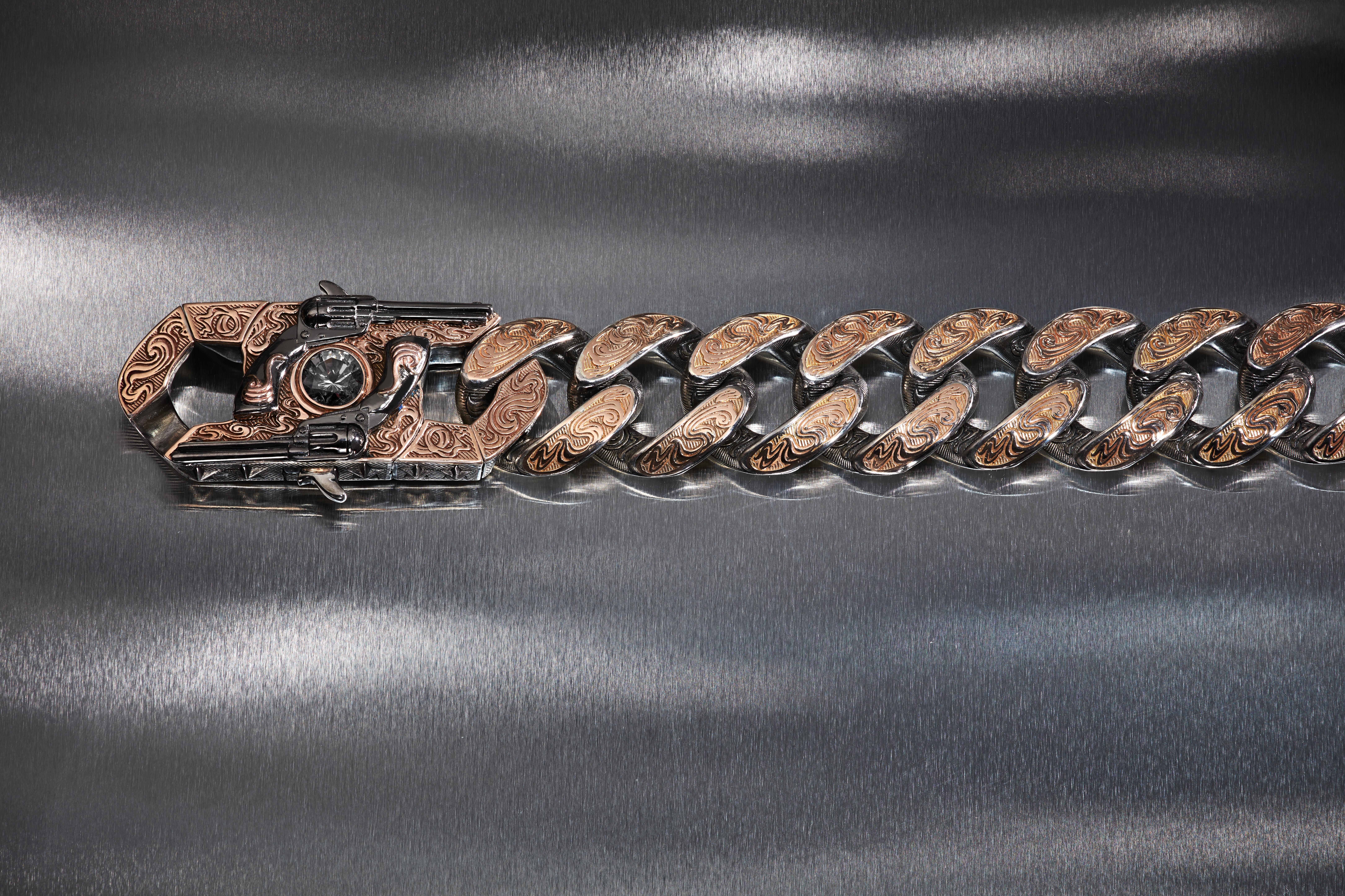 Stephen Webster’s A Wrist Full of Dollars Cuban-link bracelet with engraved rose-gold details, revolver motifs and a central grey spinel.