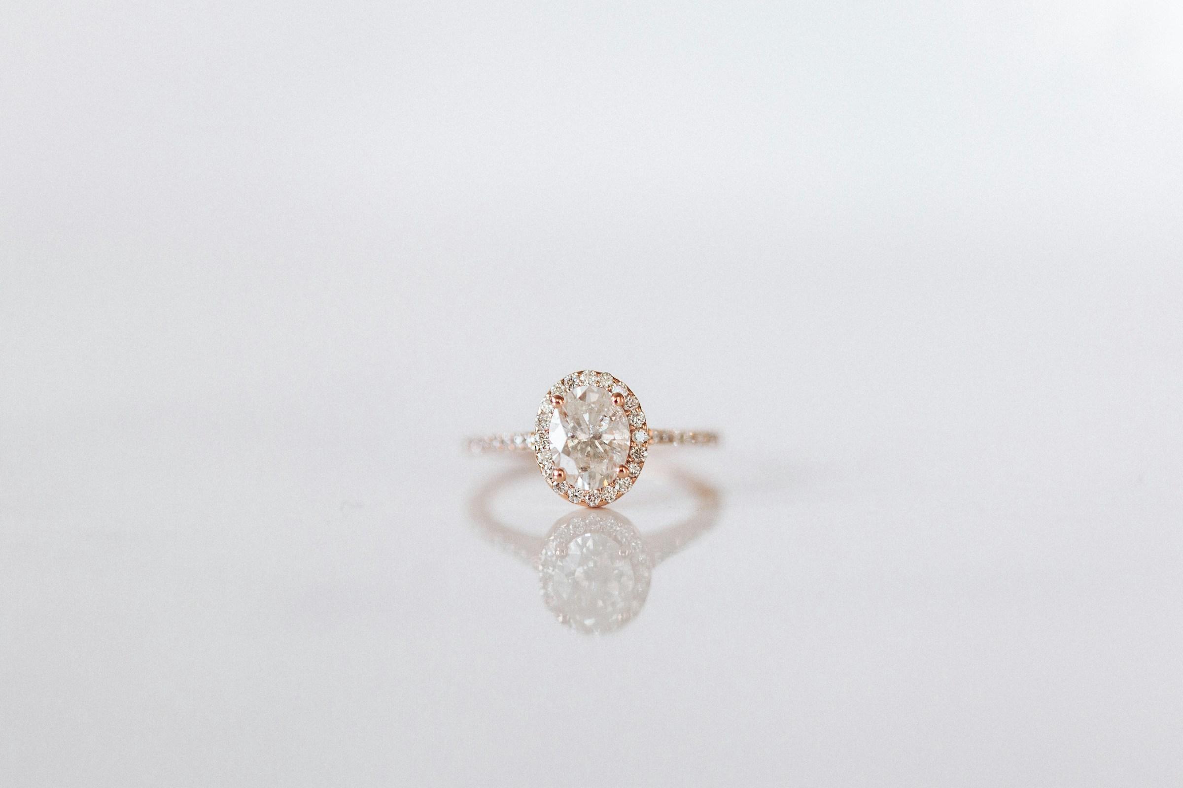 Close-up of a diamond ring on a light surface. Source: Unsplash