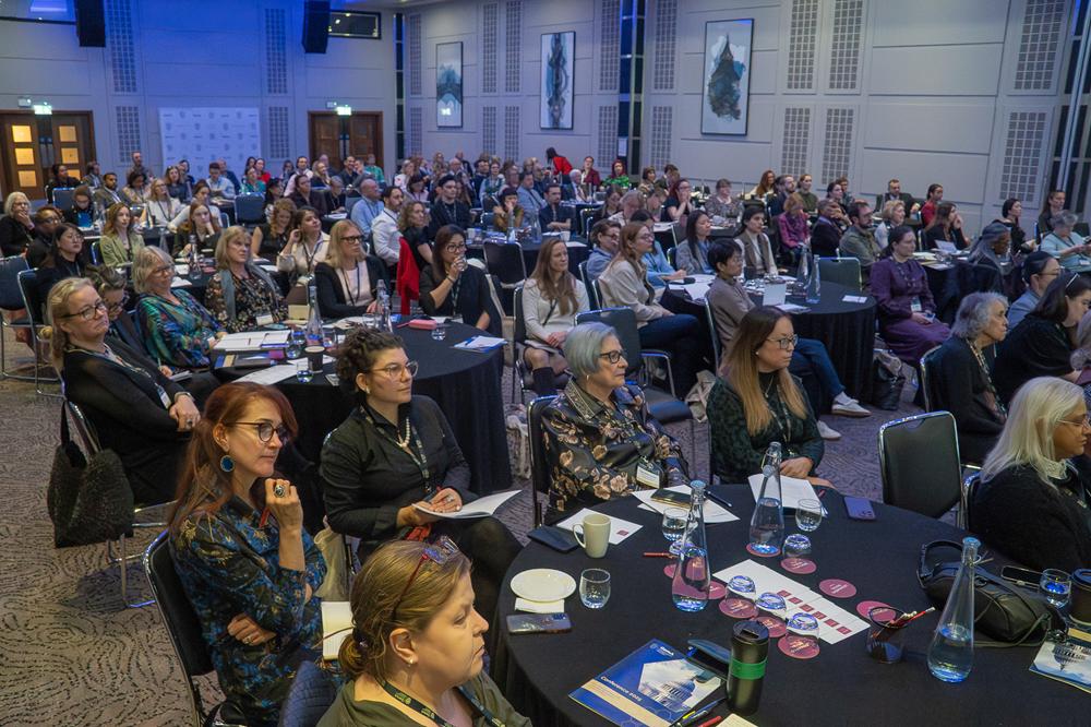 A large audience of gemmologists and jewellery professionals seated at tables during the Gem-A Conference 2025.