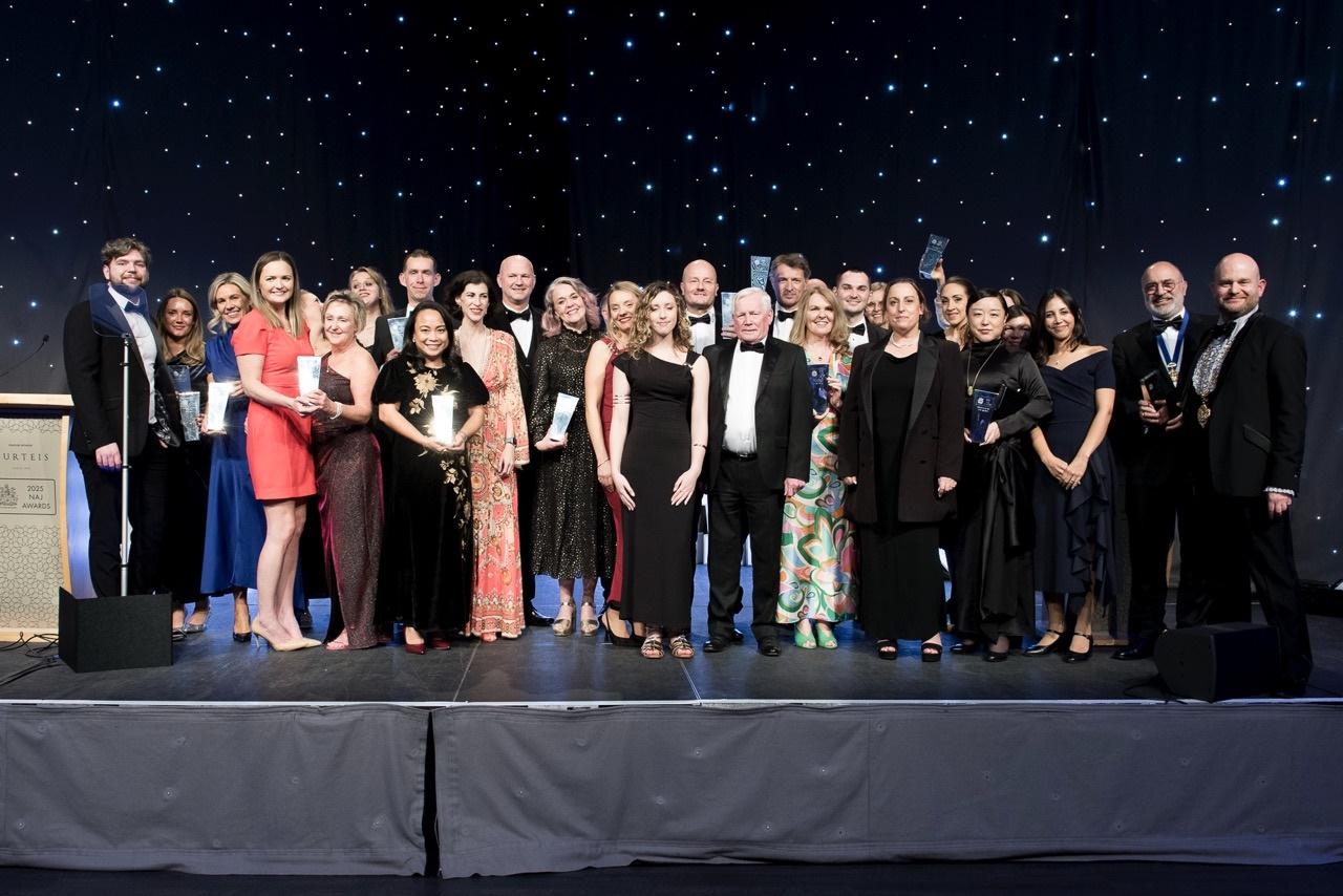 Group photograph of the 2025 NAJ Awards winners holding trophies on stage