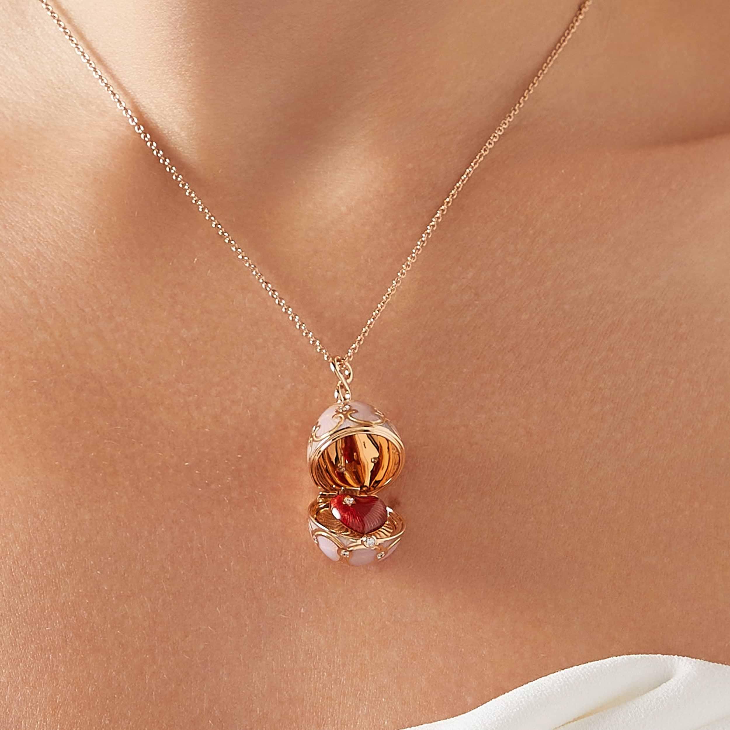 Faberg&eacute; Heritage rose gold egg pendant with pink guilloch&eacute; enamel, opening to reveal a hidden red enamel heart set with a diamond