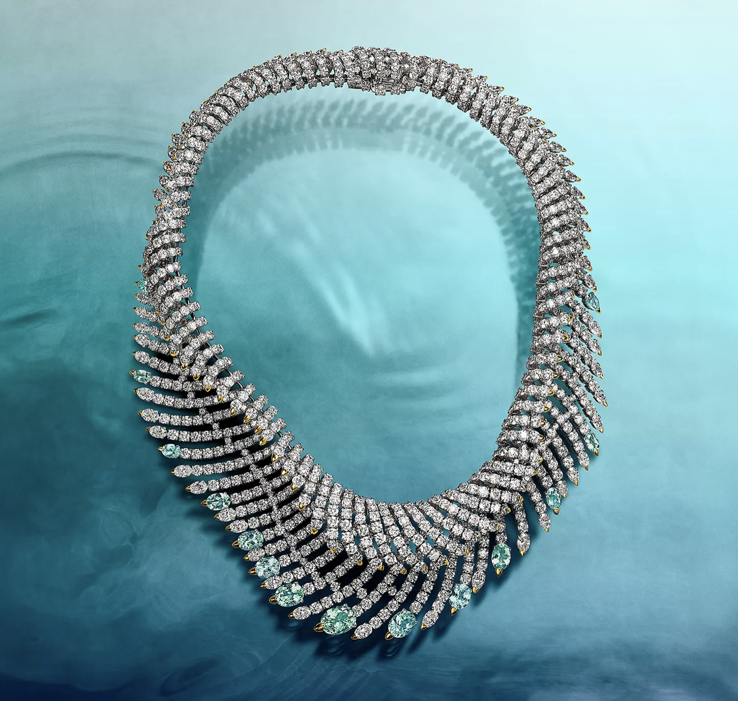 One masterpiece necklace evokes an opulent wave that crashes on the neckline; the articulated piece features diamonds that accentuate the electric hues of blue and green cuprian elbaite tourmalines of over 17 total carats