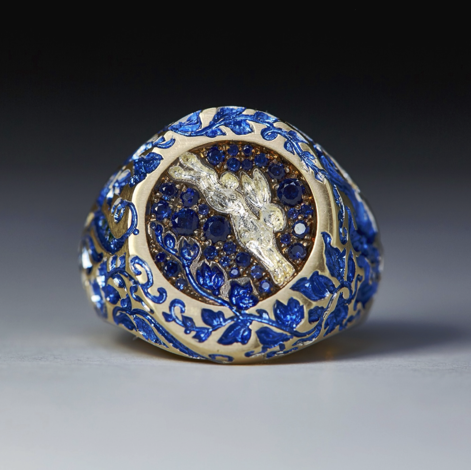 Castro Smith’s White Rabbit signet: a dreamscape in blue sapphires and enamel, beating its drum on the dark side of the moon