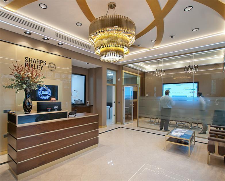 Interior of the Sharps Pixley London store, showing the reception desk, client seating and precious metals consultation area.