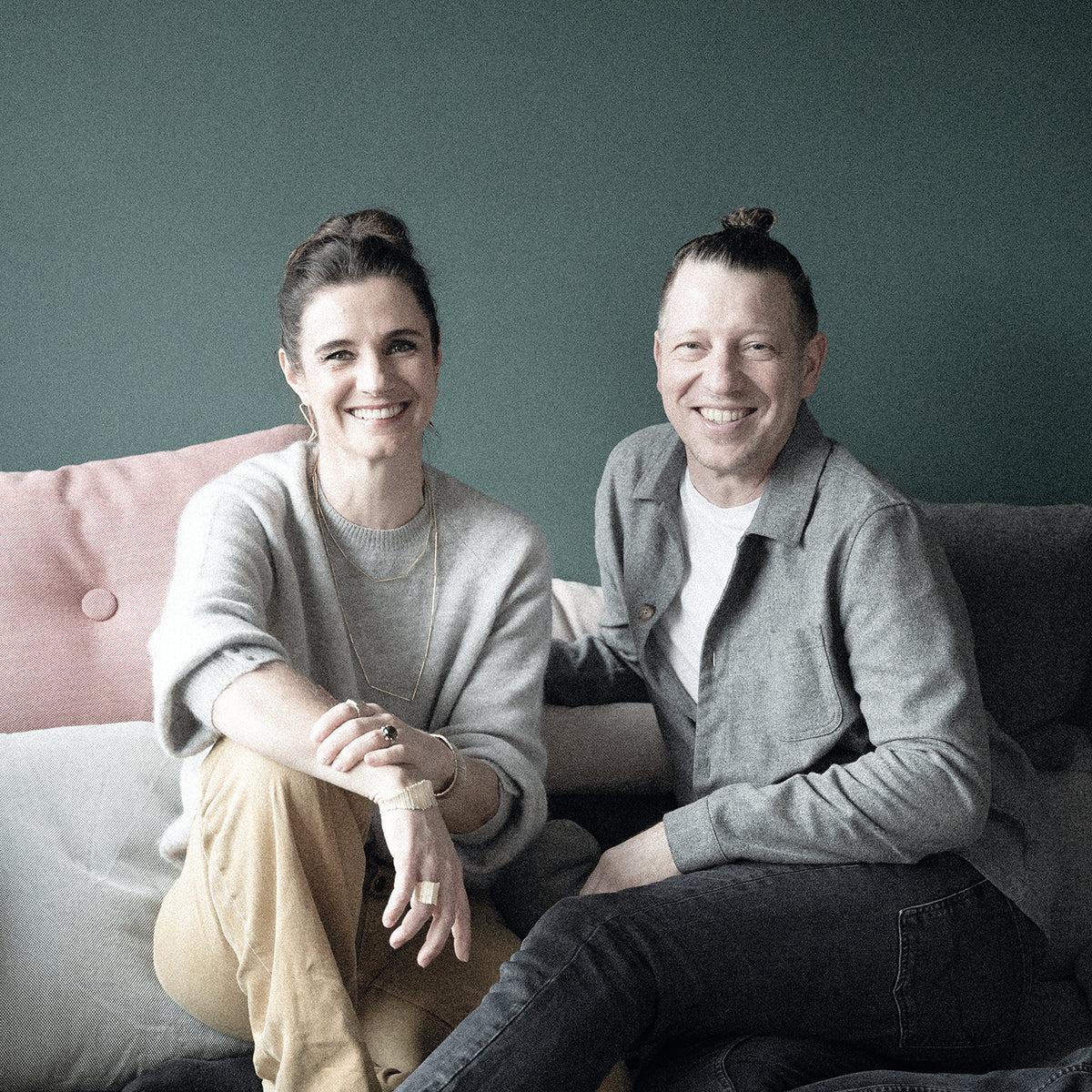 Claudia and Malte Schindler seated together, founders of No&euml;n jewellery brand focused on Fairmined gold and responsible sourcing.