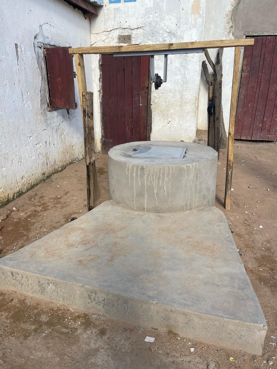 The finished well structure, complete with reinforced cover and pulley system — a vital new source of drinking water for the school