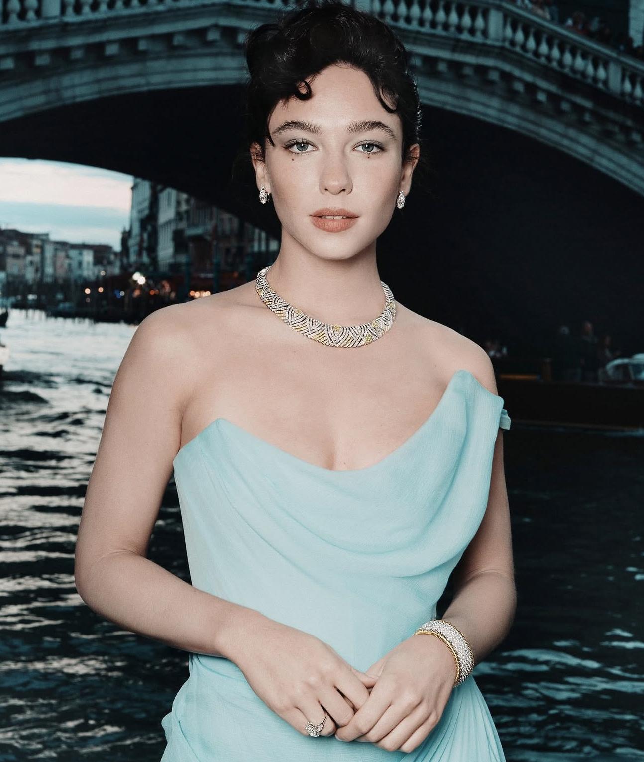Matilda De Angelis in a pale blue gown wearing a Tiffany necklace, diamond earrings, bracelet and ring beside the Grand Canal