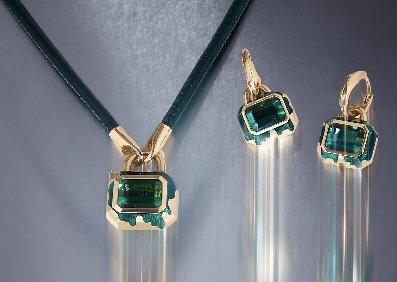 Stephen Webster necklace and earrings featuring rectangular green tourmalines, yellow gold and dripping green enamel, photographed with trails of light.
