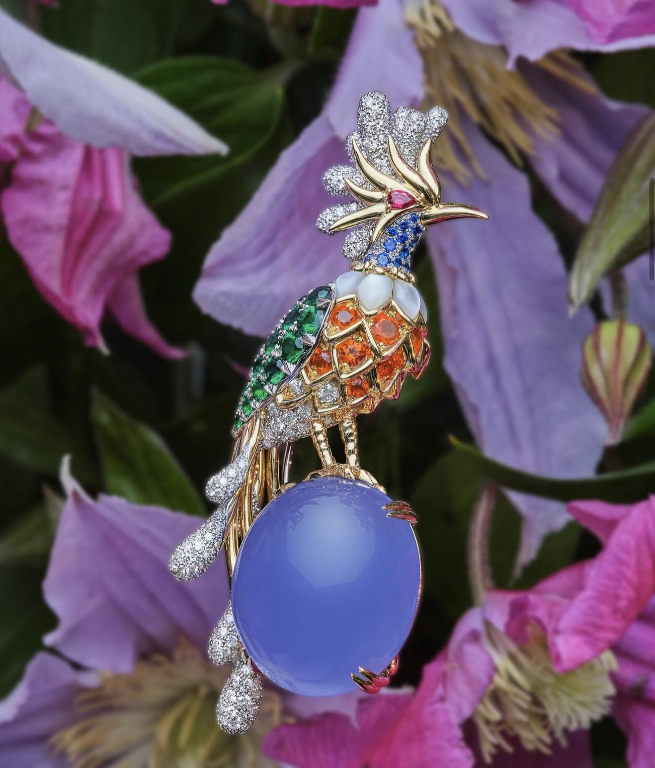Multicoloured Tiffany Paradise Bird brooch set with diamonds and coloured gemstones on a large lavender-blue cabochon
