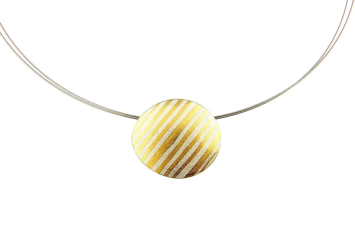 Round silver pendant necklace decorated with diagonal stripes of 24-carat gold using the Keum-Boo technique.