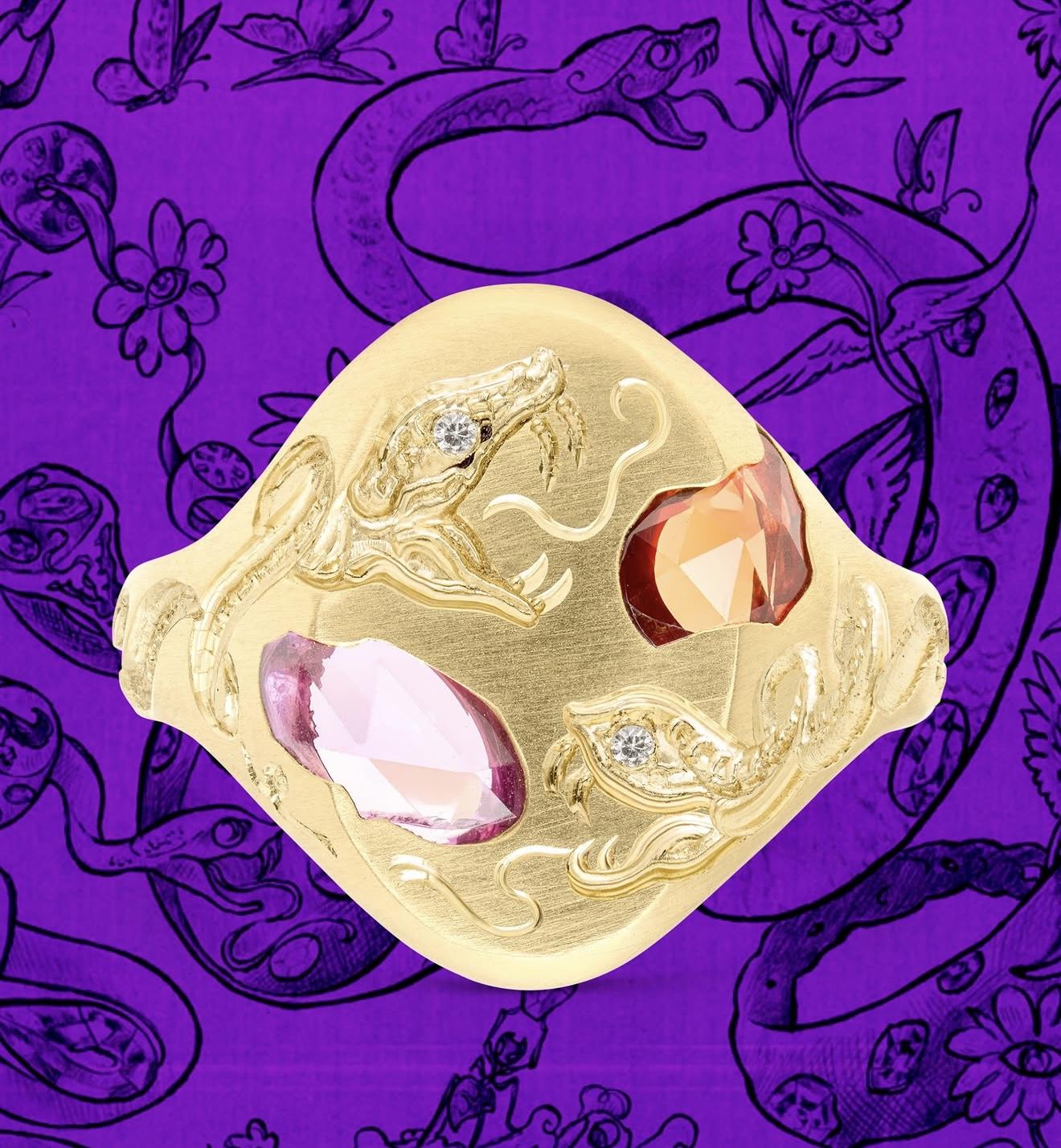 Gold signet ring from the Polly Wales x Castro Smith collection, engraved with two serpents and accented with pink, orange and white gemstones against a purple illustrated background.