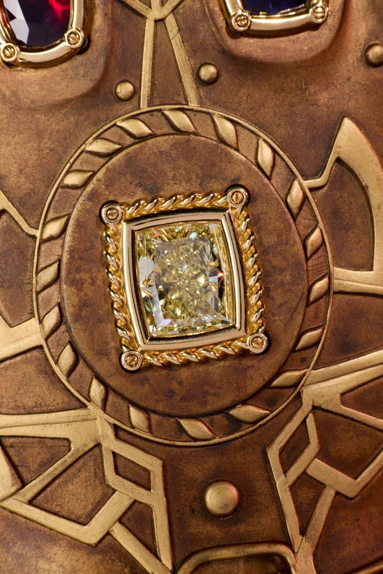 Close-up of the large rectangular yellow diamond Mind Stone set in the centre of the bronze Infinity Gauntlet