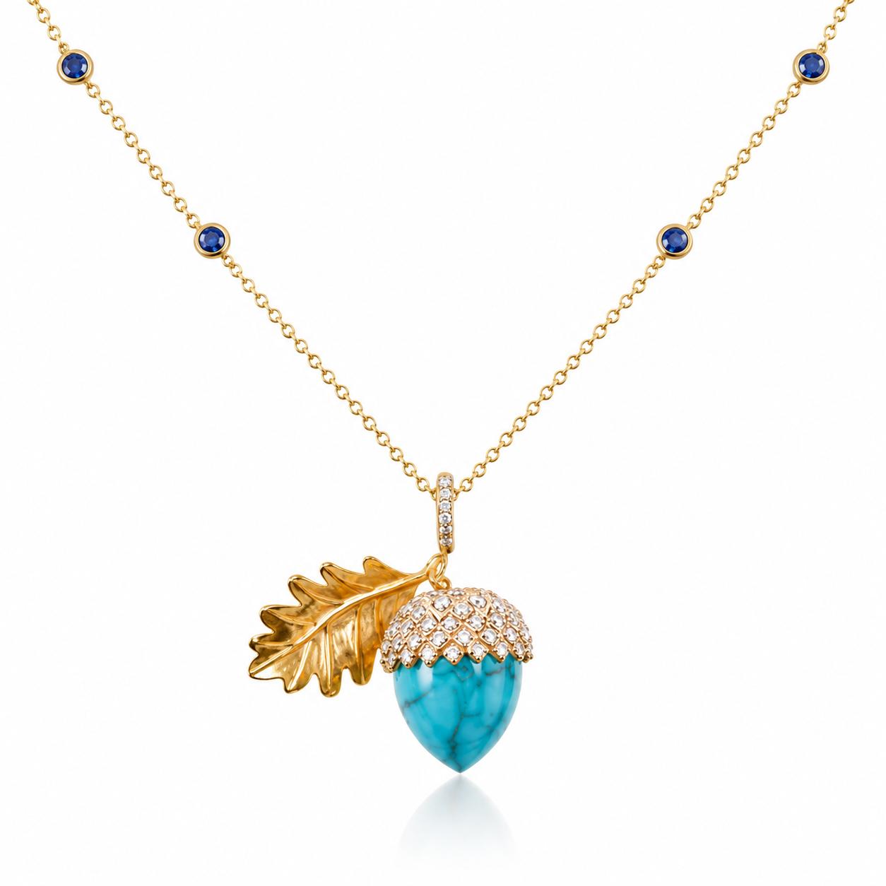 Gold necklace with blue gemstone stations and a turquoise acorn pendant featuring a diamond-set cap and gold oak leaf