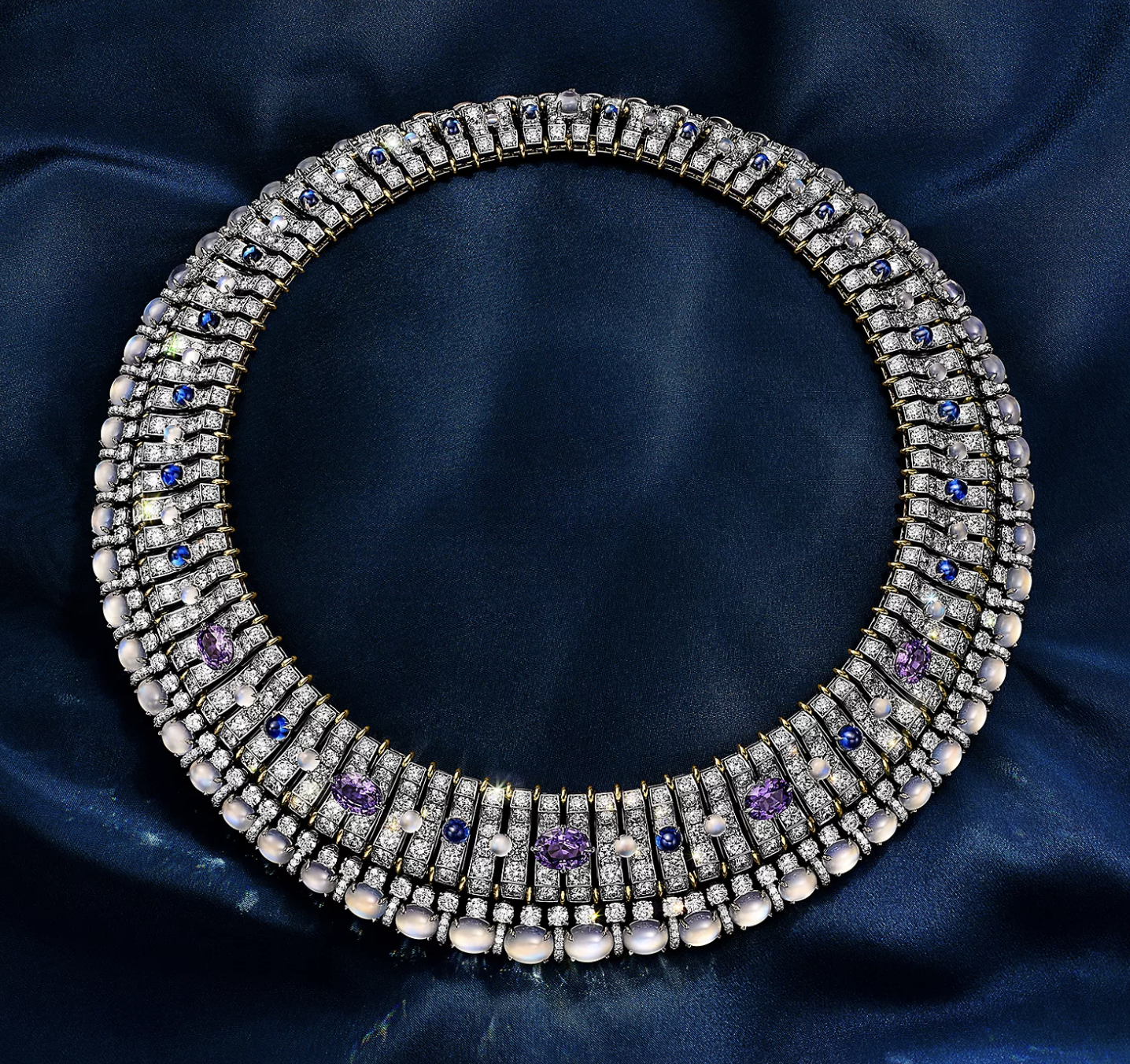 This breathtaking necklace in platinum and 18k yellow gold showcases unenhanced purple sapphires of over 11 total carats, blue sapphires, moonstones and diamonds