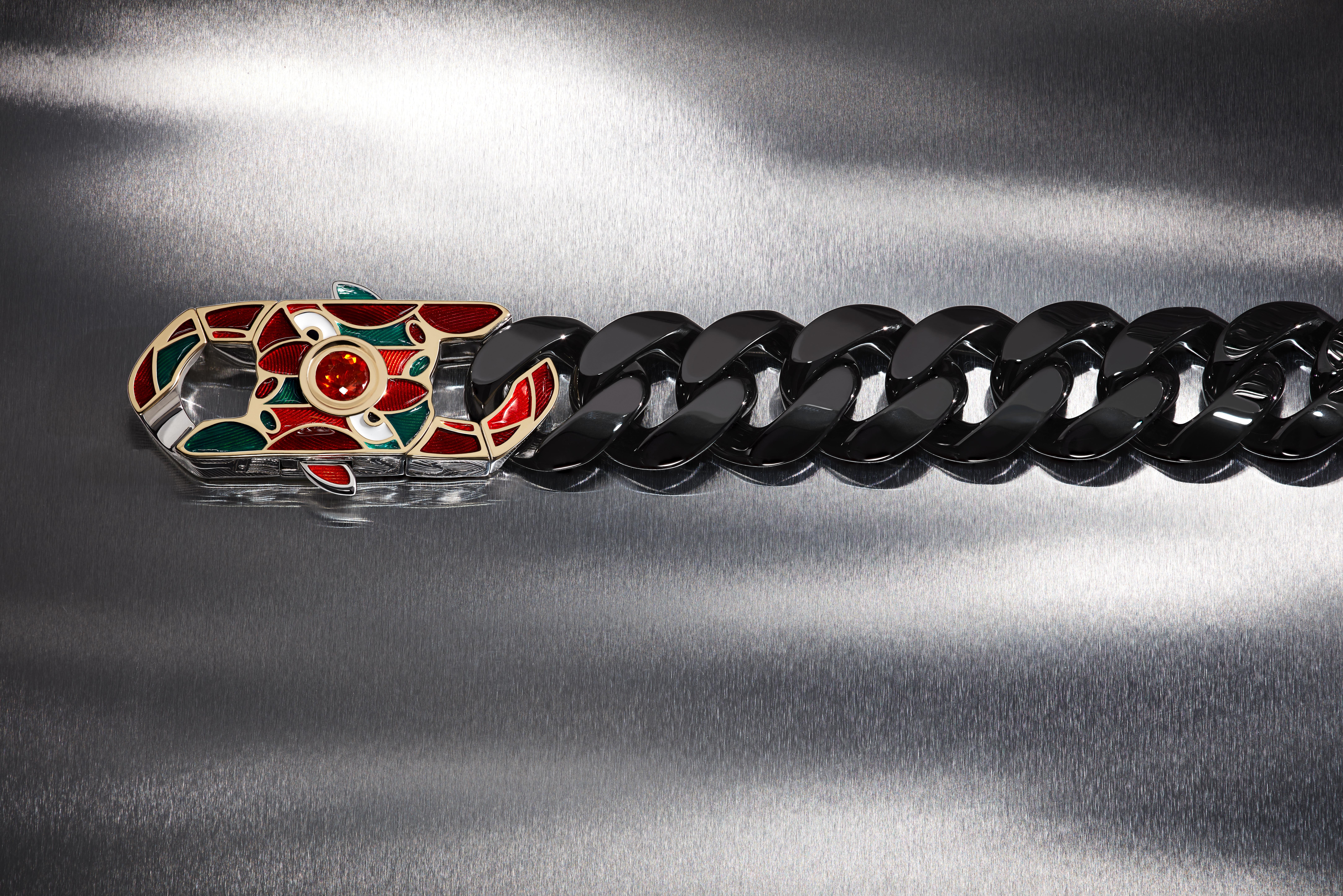Stephen Webster’s Out of the Cube bracelet with black ceramic Cuban links, colourful enamel detailing and a central fire opal.