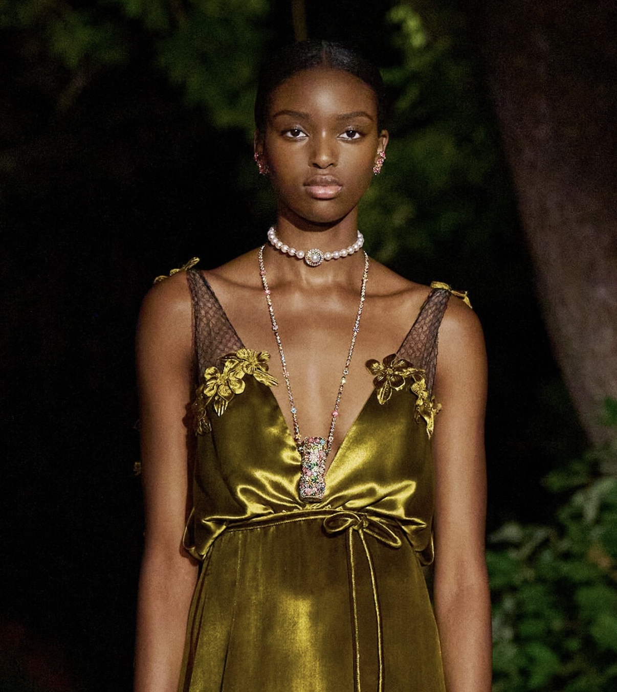 Model wearing Dior’s Rouge Premier lipstick pendant as a sautoir necklace during the Paris presentation—where haute joaillerie met couture styling. Imagery: Courtesy of Dior