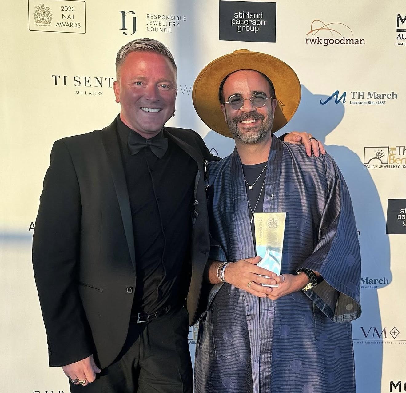 Andrew Martyniuk and jewellery designer Julien Riad Sahyoun holding his Jewellery Designer of the Year award at the 2023 NAJ Awards.