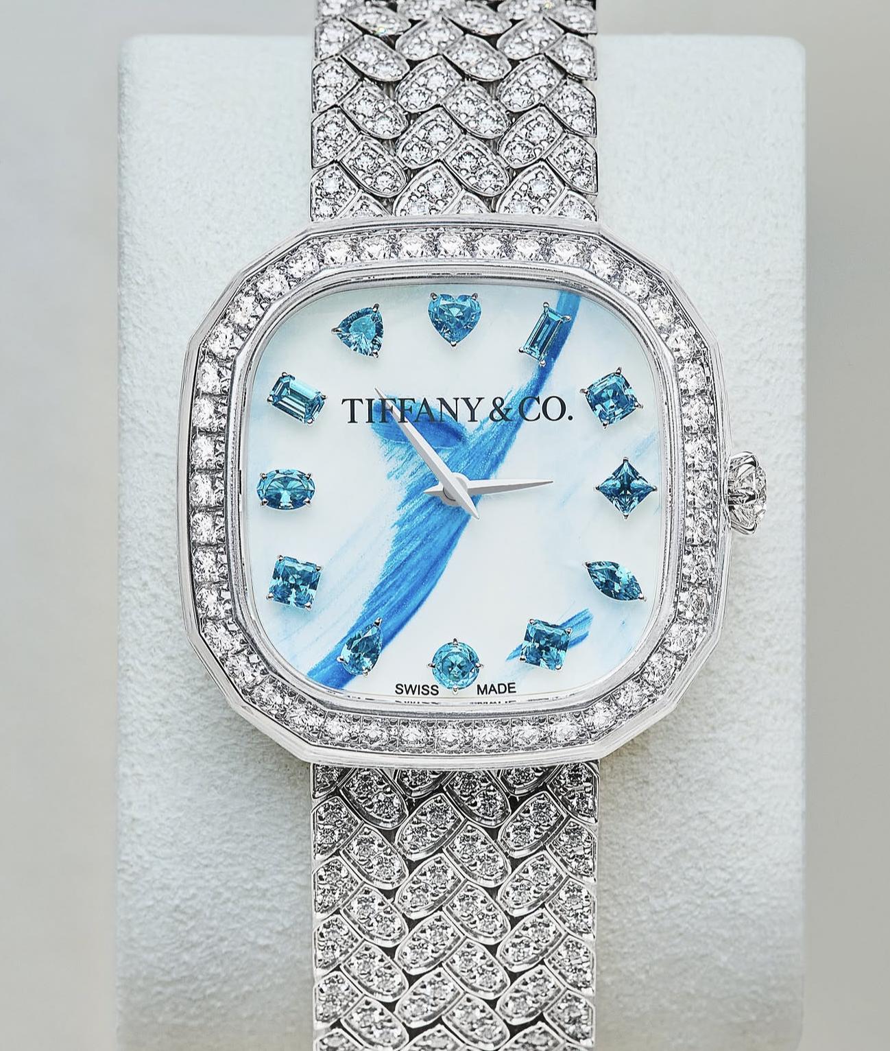 Tiffany diamond watch with a pale dial, blue painted detail and blue gemstone hour markers.