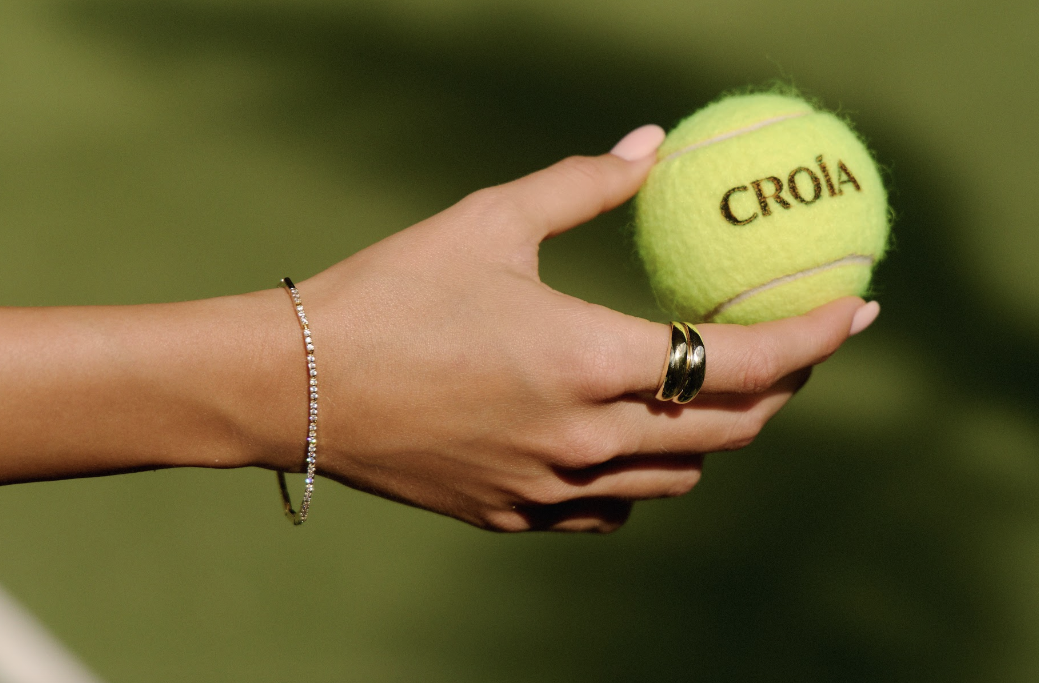 Subtle branding: CROÍA’s logo makes its mark as a gold-plated bracelet curves effortlessly around the wrist. Credit: CROÍA Jewellery
